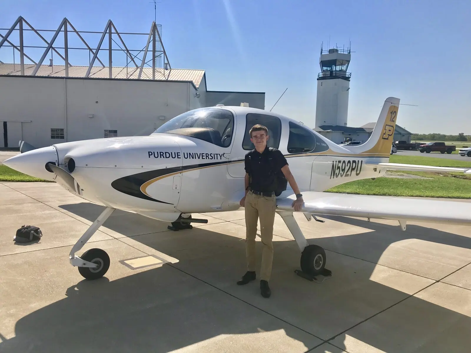 Gheorghe Ciobanu beside a Purdue University Cirrus training aircraft