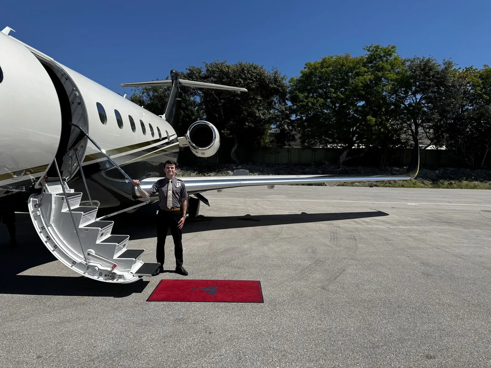 Gheorghe Ciobanu beside a Flexjet jet on the ramp